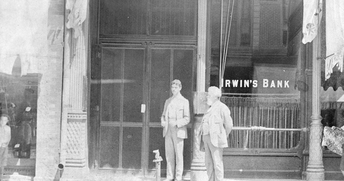 Unidentified men standing in front of Irwin’s Bank in Columbus, Indiana